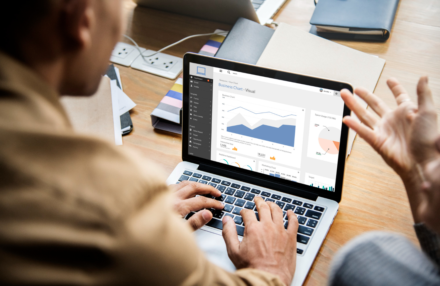 Analyst reviewing privacy analytics dashboard on laptop in office