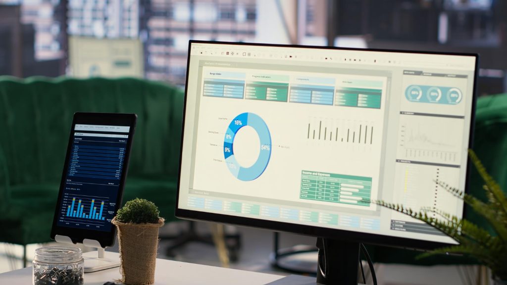 Analytics dashboard on monitor and tablet showing different analytics interfaces