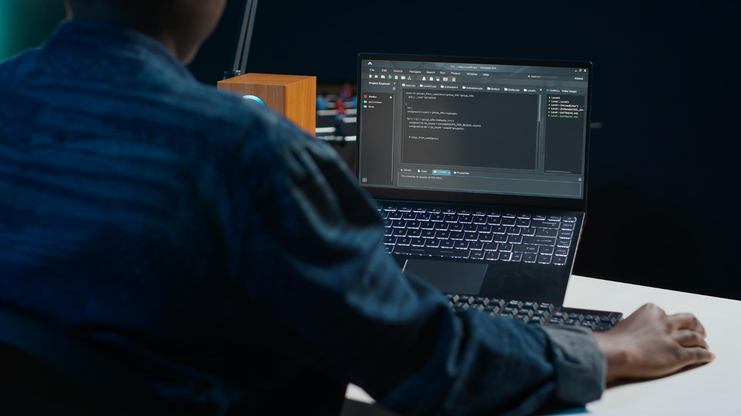 Developer configuring Umami analytics on laptop with dark theme code editor